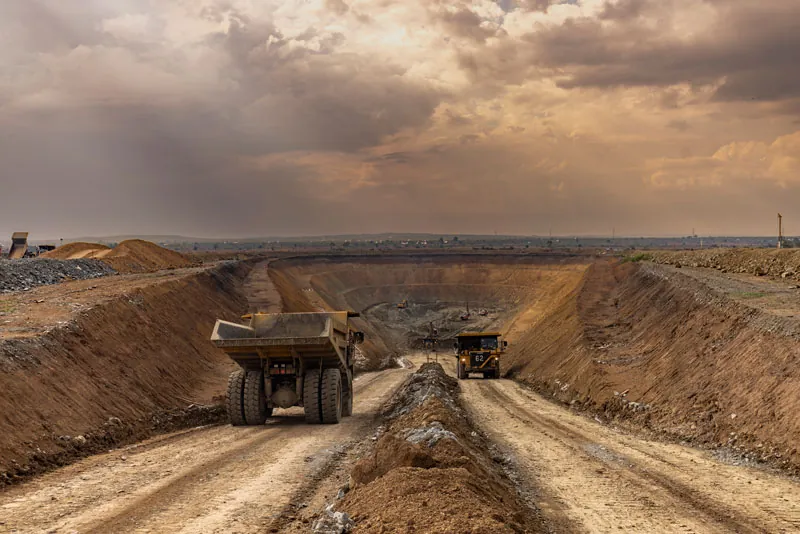 Haul trucks at dusk at Bulyanhulu