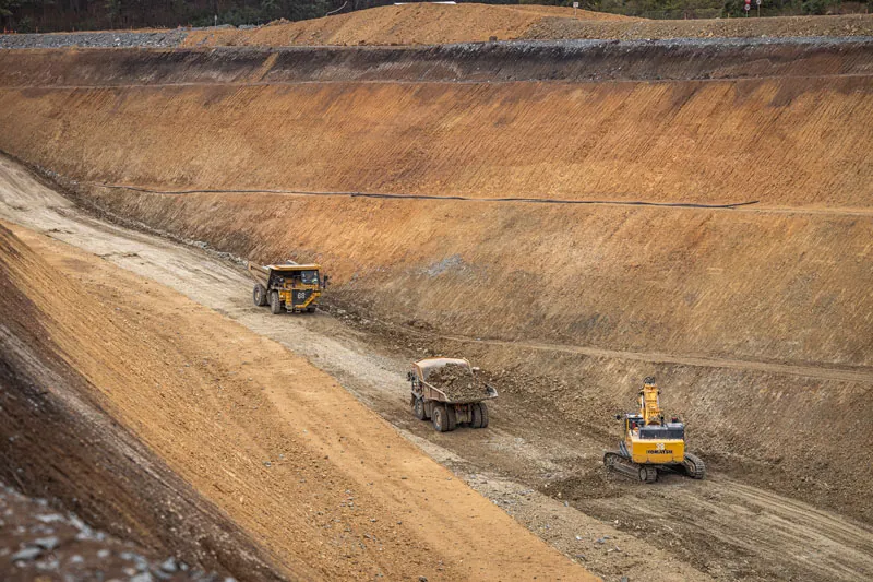 Trucks climbing a pit ramp